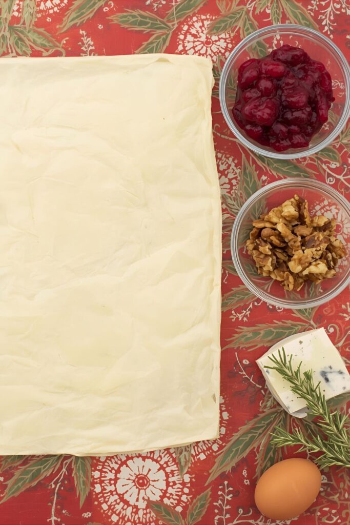  A flat-lay photo collage of the ingredients used to make cheesy cranberry bites.)