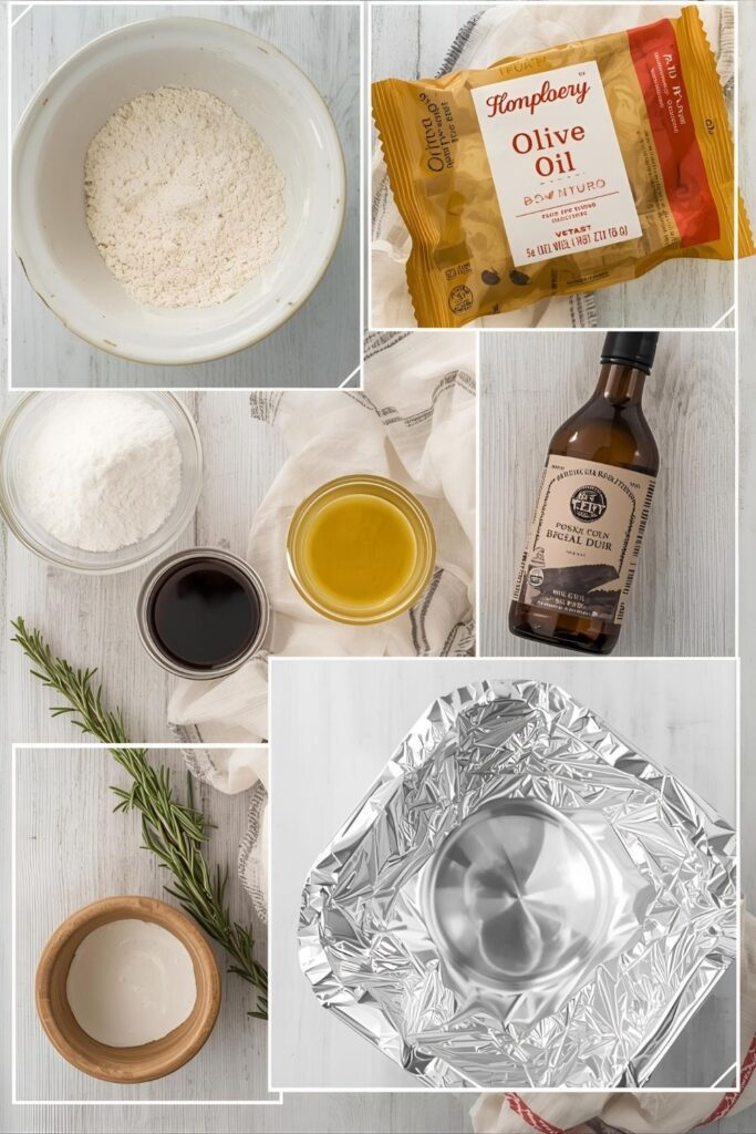 A flat lay of the main ingredients for the bread basket: flour, yeast, olive oil, and fresh rosemary, with a bowl mold and foil on the side, arranged on a kitchen counter.