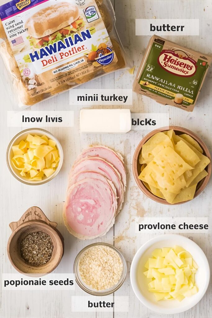 A vibrant flat lay of the main ingredients for mini turkey sliders: a pack of Hawaiian rolls, thinly sliced deli turkey, provolone cheese, and ingredients for the buttery topping.