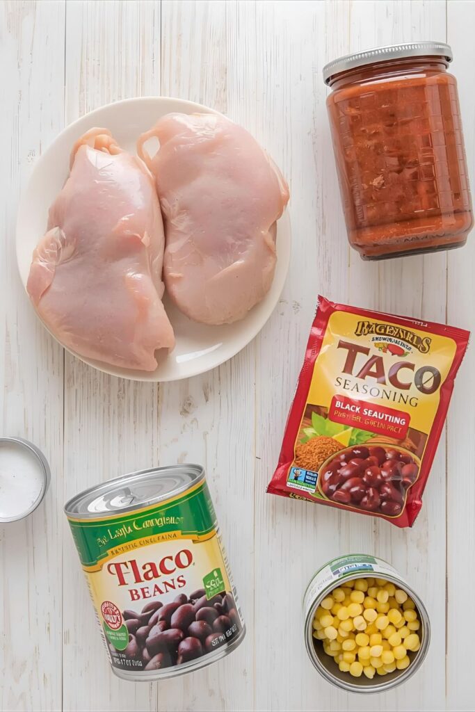 A collage of the five ingredients for slow cooker salsa chicken: chicken breasts, salsa, taco seasoning, black beans, and corn.