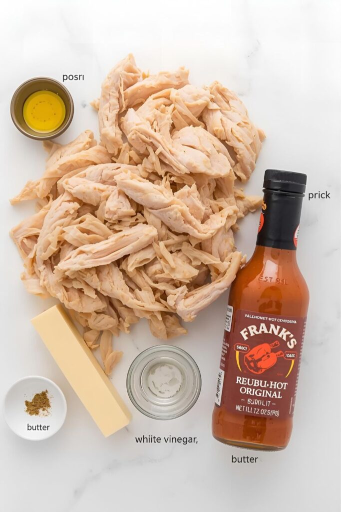 A collage of fresh, raw ingredients for buffalo chicken: cooked shredded chicken, a bottle of Frank's RedHot, a stick of butter, garlic powder, and white vinegar.