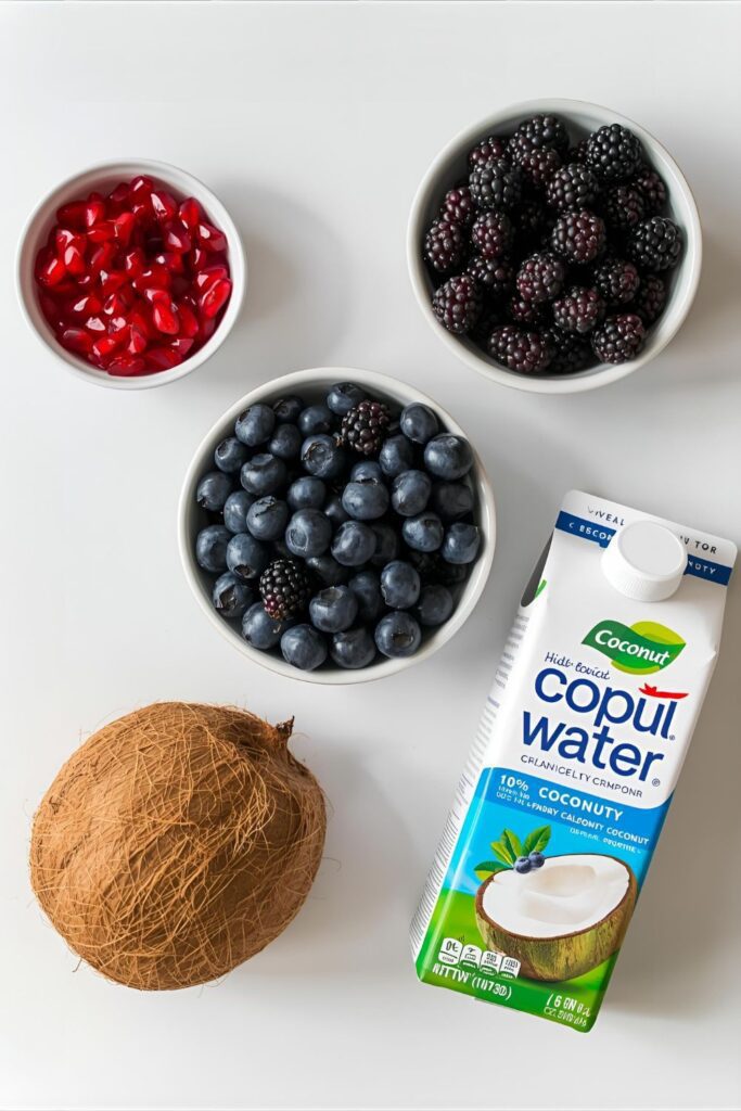 A collage of fresh ingredients for Nature's Cereal: pomegranate seeds, blueberries, blackberries, and coconut water.