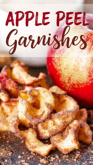 A pile of perfectly baked, curled, cinnamon-sugar apple peel crisps (garnishes) on a rustic wooden board, next to a peeled apple. Text overlay reads: APPLE PEEL GARNISHES