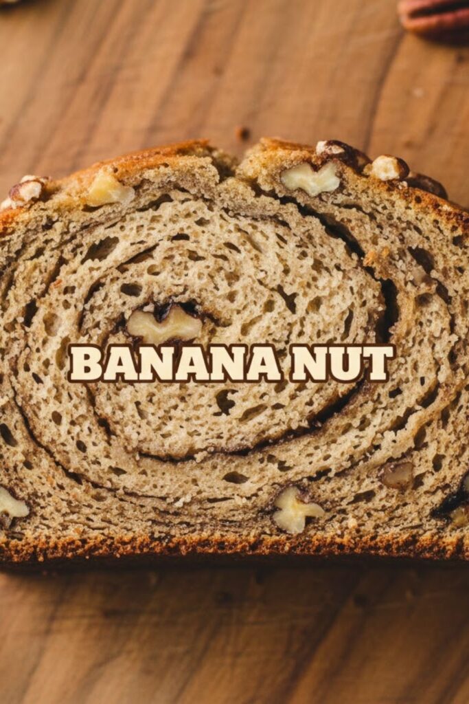 A close-up, overhead photo of a warm slice of banana nut bread showing the moist texture and chopped nuts, with the bold text overlay: BANANA NUT.