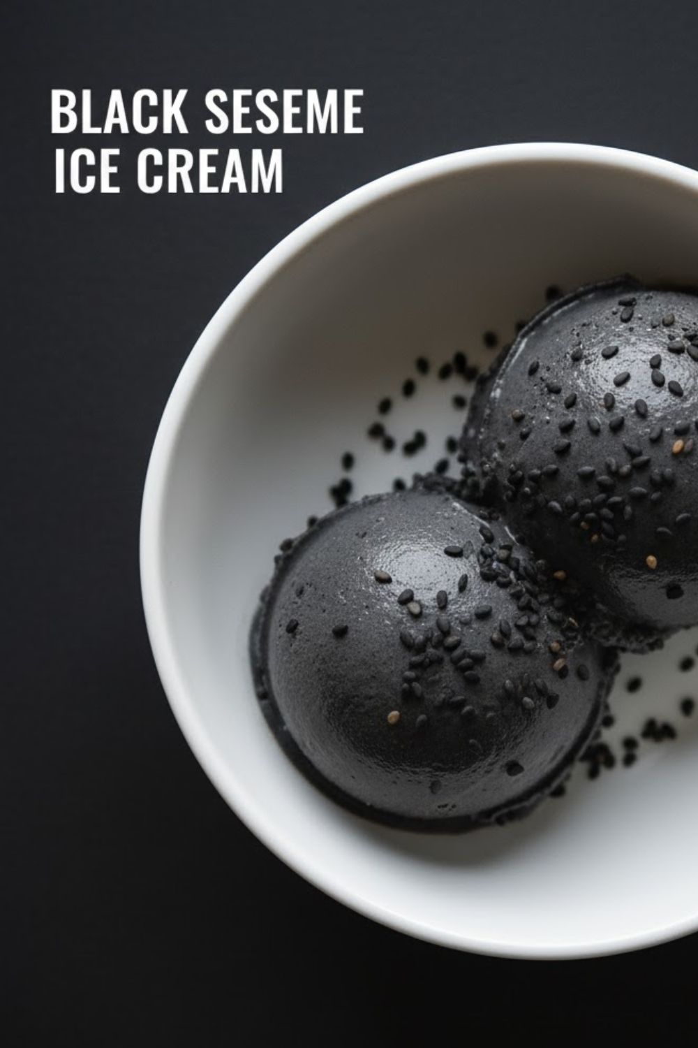 A close-up, overhead photo of perfectly scooped black sesame ice cream in a white bowl, garnished with sesame seeds, featuring the bold text overlay: BLACK SESAME ICE CREAM.