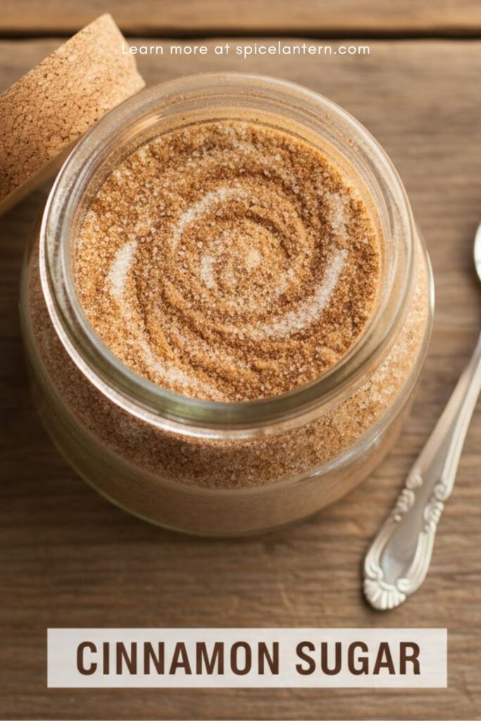Jar of perfectly mixed cinnamon sugar with a spoon and text overlay 'CINNAMON SUGAR'.