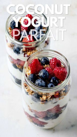 Two tall glass jars showing clear, beautiful layers of coconut yogurt, granola, and fresh mixed berries, with toasted coconut on top. Text overlay reads: COCONUT YOGURT PARFAIT