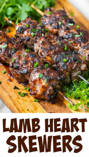A graphic overlaying the bold text "LAMB HEART SKEWERS" on a stunning, close-up image of beautifully grilled and seasoned lamb heart skewers, ready to eat.