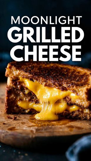 A crispy, golden-brown grilled cheese sandwich sliced diagonally, showing the melted, stretchy layers of three cheeses, set against a dark, moody backdrop. Text overlay reads: MOONLIGHT GRILLED CHEESE