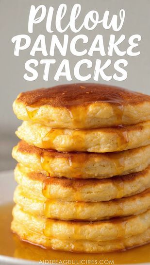 A close-up, highly detailed photo of a tall, jiggly stack of golden-brown fluffy pancakes drizzled heavily with maple syrup. The text overlay prominently displays "PILLOW PANCAKE STACKS" in a bold, inviting font.