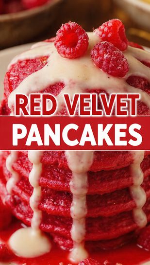 A close-up, vibrant overhead photo of a stack of fluffy red velvet pancakes drizzled with white cream cheese glaze and topped with berries, featuring the bold text overlay: RED VELVET PANCAKES.