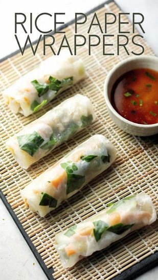 A close-up shot of several fresh, tightly rolled Vietnamese spring rolls with shrimp and herbs visible through the translucent wrapper. Text overlay reads: RICE PAPER WRAPPERS