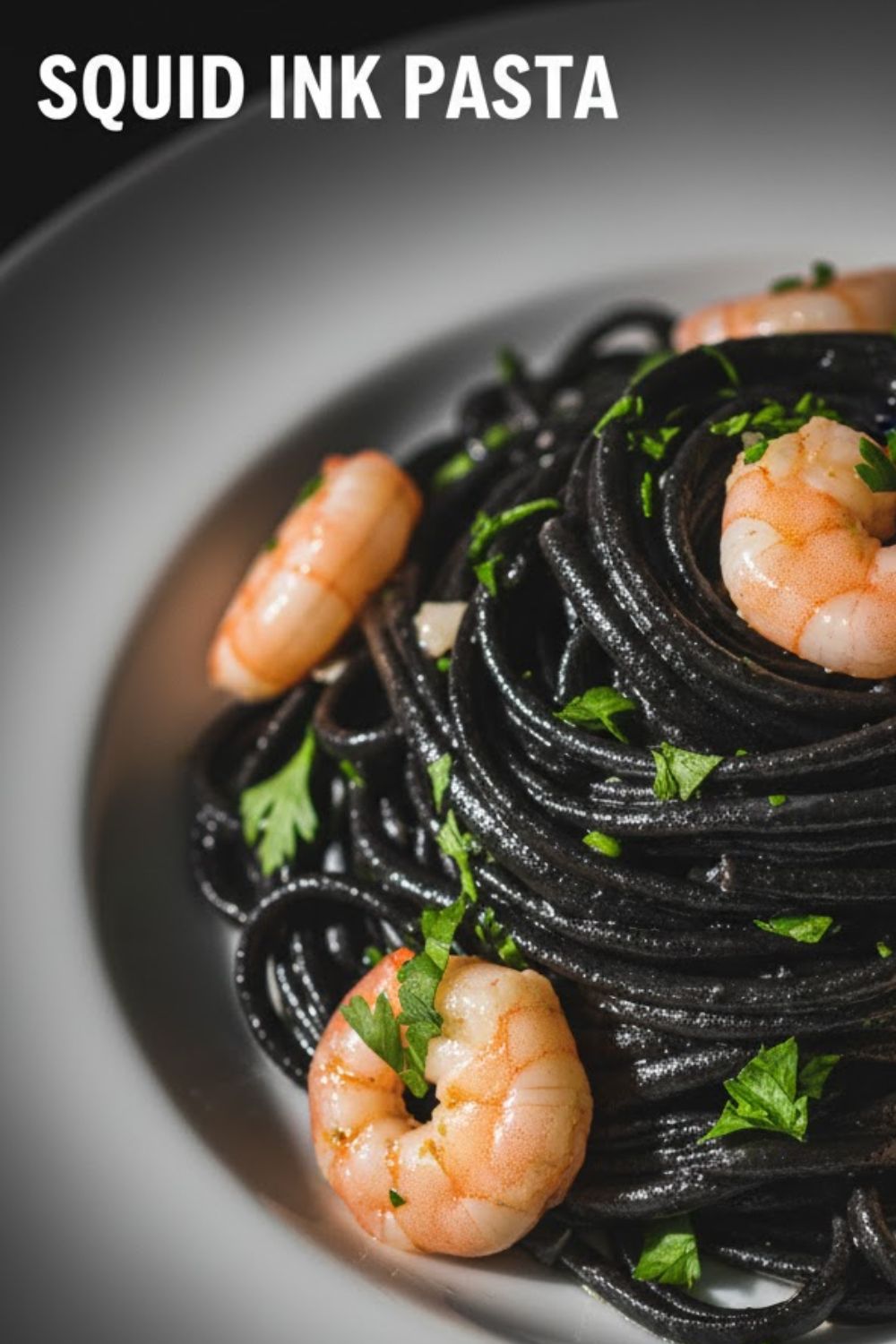 A close-up, vibrant overhead photo of dark black squid ink pasta tossed with pink shrimp and parsley, featuring the bold text overlay: SQUID INK PASTA.