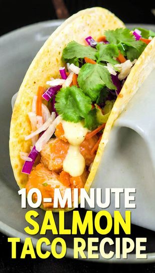A close-up shot of a vibrant salmon taco, loaded with flaky salmon, zesty sauce, and crunchy slaw, garnished with fresh cilantro, with a blurred background of more tacos. The text overlay reads: "10-MINUTE SALMON TACO RECIPE"