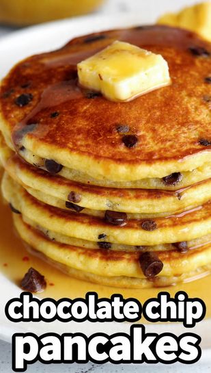 A highly aesthetic stack of three tall, golden-brown fluffy chocolate chip pancakes with visible melted chocolate, heavily drizzled with maple syrup, and topped with melting butter, featuring the main keyword text overlay.