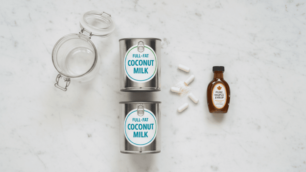 Ingredients for homemade coconut yogurt including canned coconut milk and probiotic capsules.