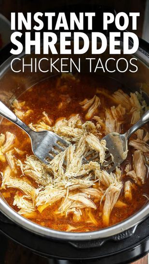 close-up shot of the Instant Pot inner pot filled with deeply seasoned, shredded chicken soaking in a rich taco liquid, with two forks pulling apart the meat. The text overlay reads: "INSTANT POT SHREDDED CHICKEN TACOS"