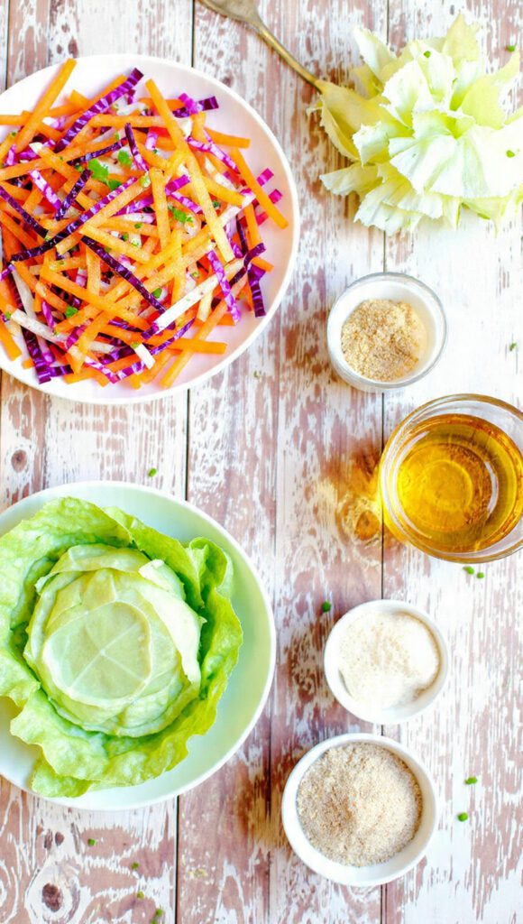 A collage showing the essential ingredients: peeled rainbow carrots (purple, yellow, orange), green cabbage, a small bowl of apple cider vinegar, olive oil, and honey/Dijon.