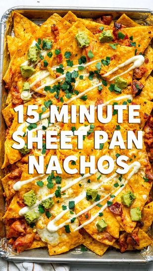 A vibrant, close-up overhead shot of a large sheet pan overflowing with melted, bubbly, 15-minute sheet pan nachos, topped with sour cream, guacamole, and cilantro, featuring the main keyword text overlay.