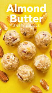 A wooden bowl filled with round almond butter energy balls and text overlay "Almond Butter Energy Balls".
