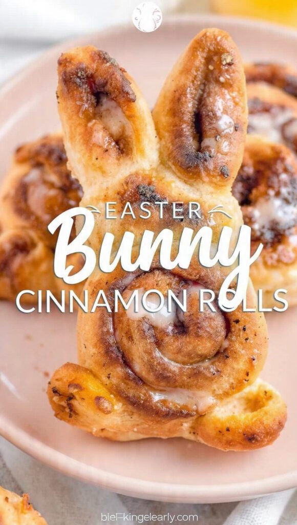 A close-up of a decorated easter bunny cinnamon roll with cream cheese frosting.