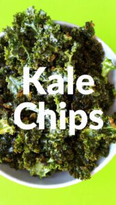 A bowl of perfectly crispy kale chips with visible seasoning and text overlay "Kale Chips".