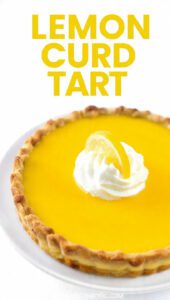 A close-up of a bright yellow lemon curd tart with fresh raspberries and text overlay "Lemon Curd Tart".