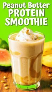 A tall glass of creamy peanut butter protein smoothie topped with crushed peanuts with text overlay "Peanut Butter Protein Smoothie"