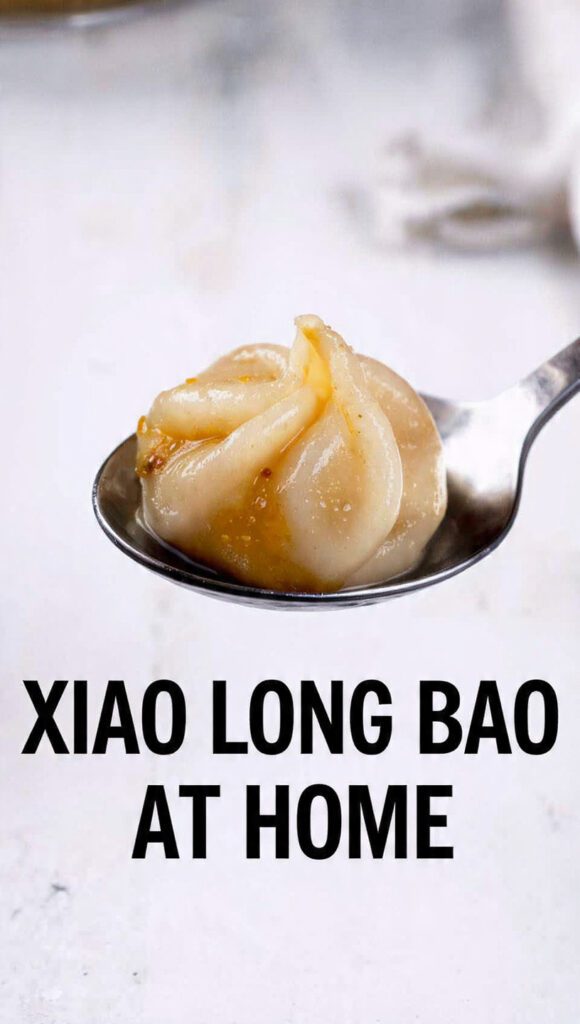 Steaming bamboo basket of xiao long bao with bold text overlay.